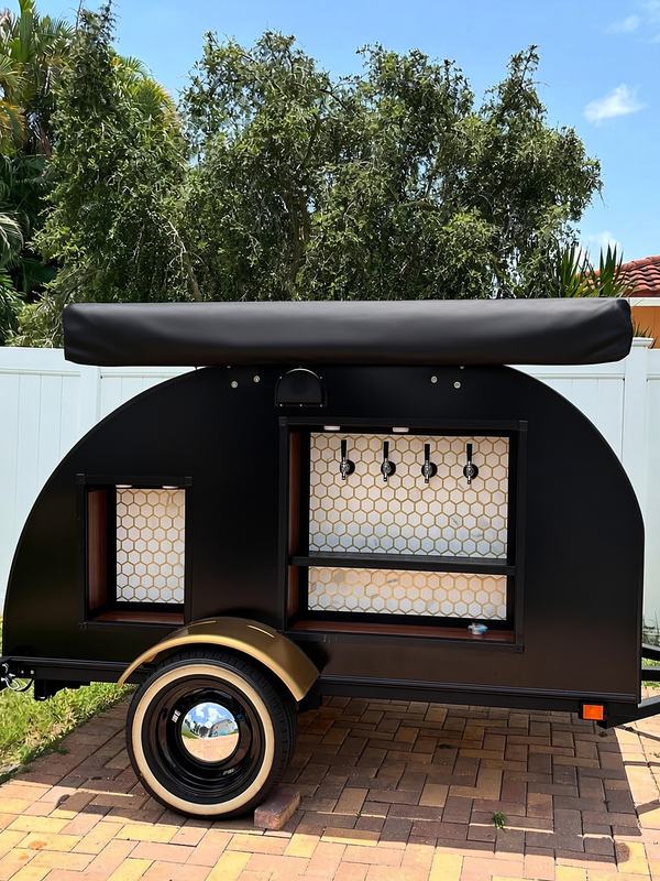 Self-serve tap trailer set up on a brick patio for a backyard party